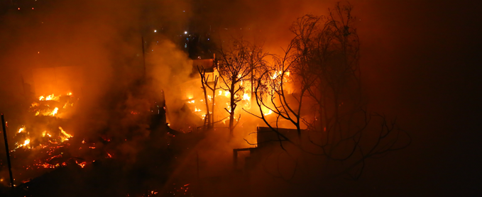 Wildfire burning trees and houses